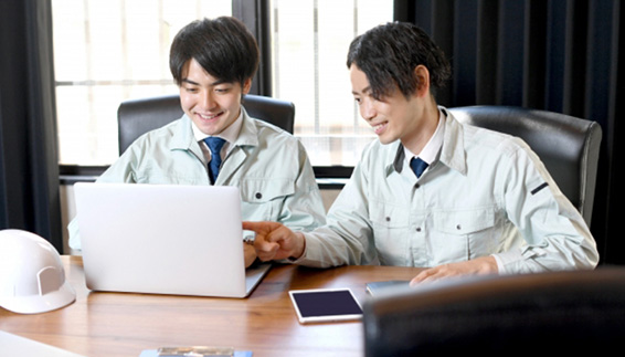 employees in front of a laptop